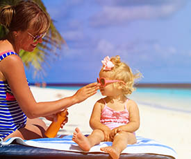 mother applying sunblock daughter